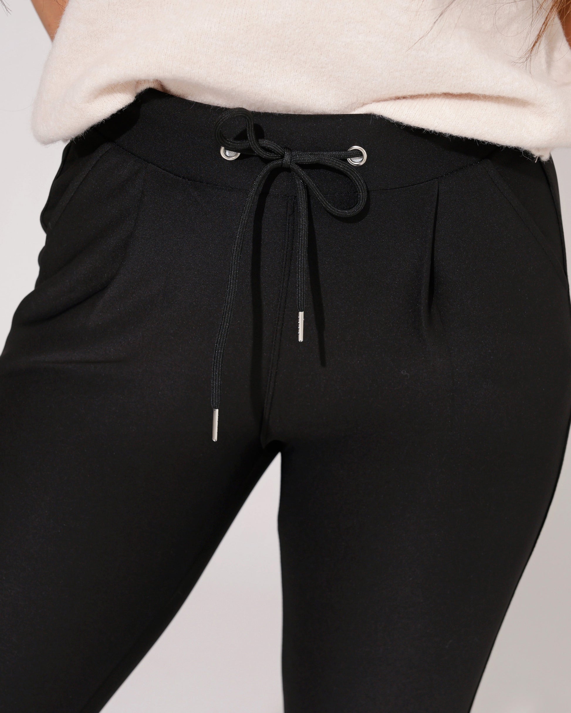 Lifestyle shot of the black comfort skinny trousers paired with a stylish top, suitable for various occasions.