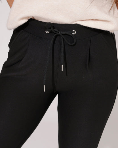 Lifestyle shot of the black comfort skinny trousers paired with a stylish top, suitable for various occasions.