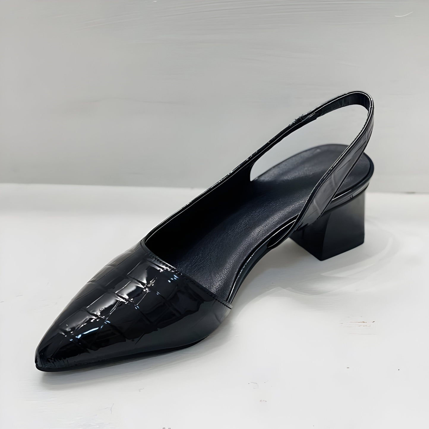 Front view of black orthopaedic comfortable heels, displaying the sleek silhouette and premium leather.
