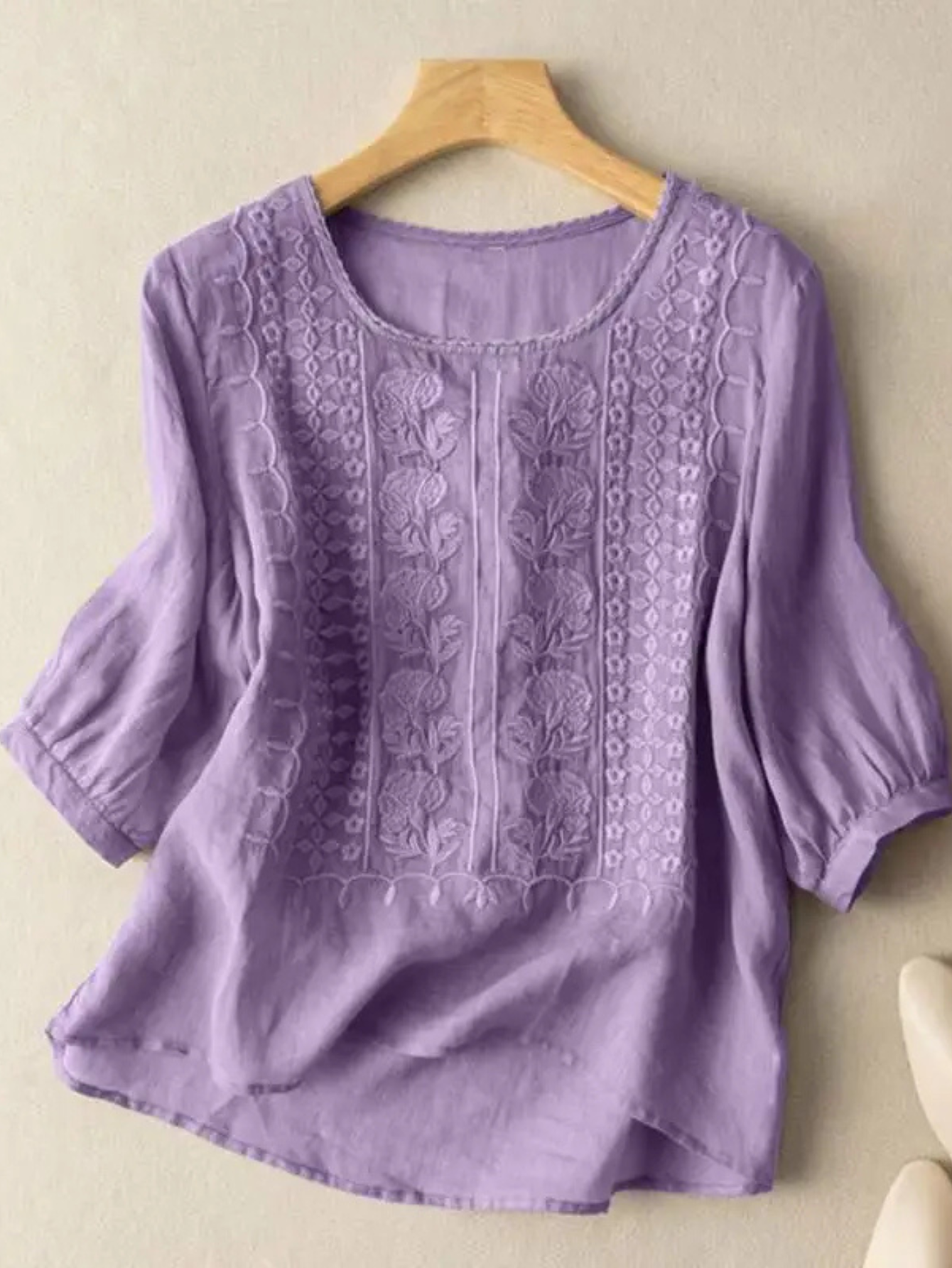 Lifestyle shot of the purple Elodie embroidered blouse styled with accessories, suitable for a relaxed outing.