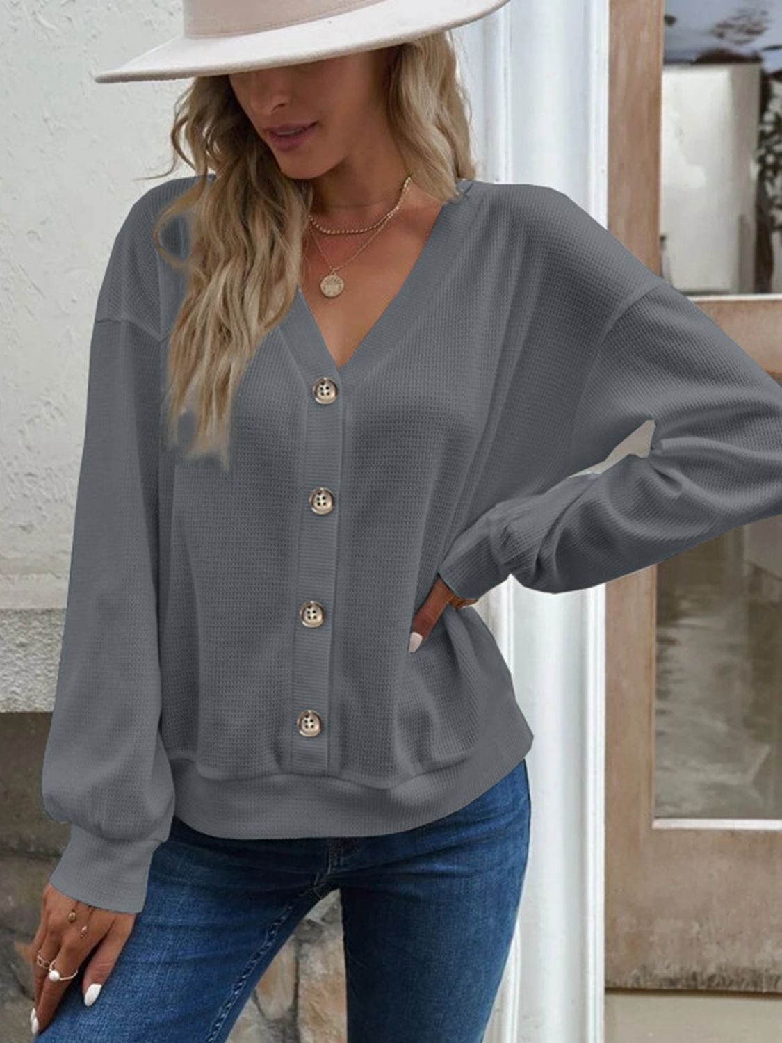 Front view of the Elowen dark grey waffle-knit V-neck blouse, perfect for a sophisticated casual outfit.