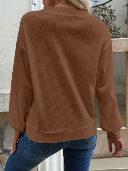 Model in the caramel Elowen blouse, demonstrating its versatility for different body types.