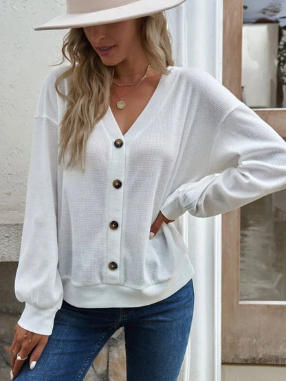 Back view of the white Elowen waffle-knit blouse, illustrating its simple and elegant design.