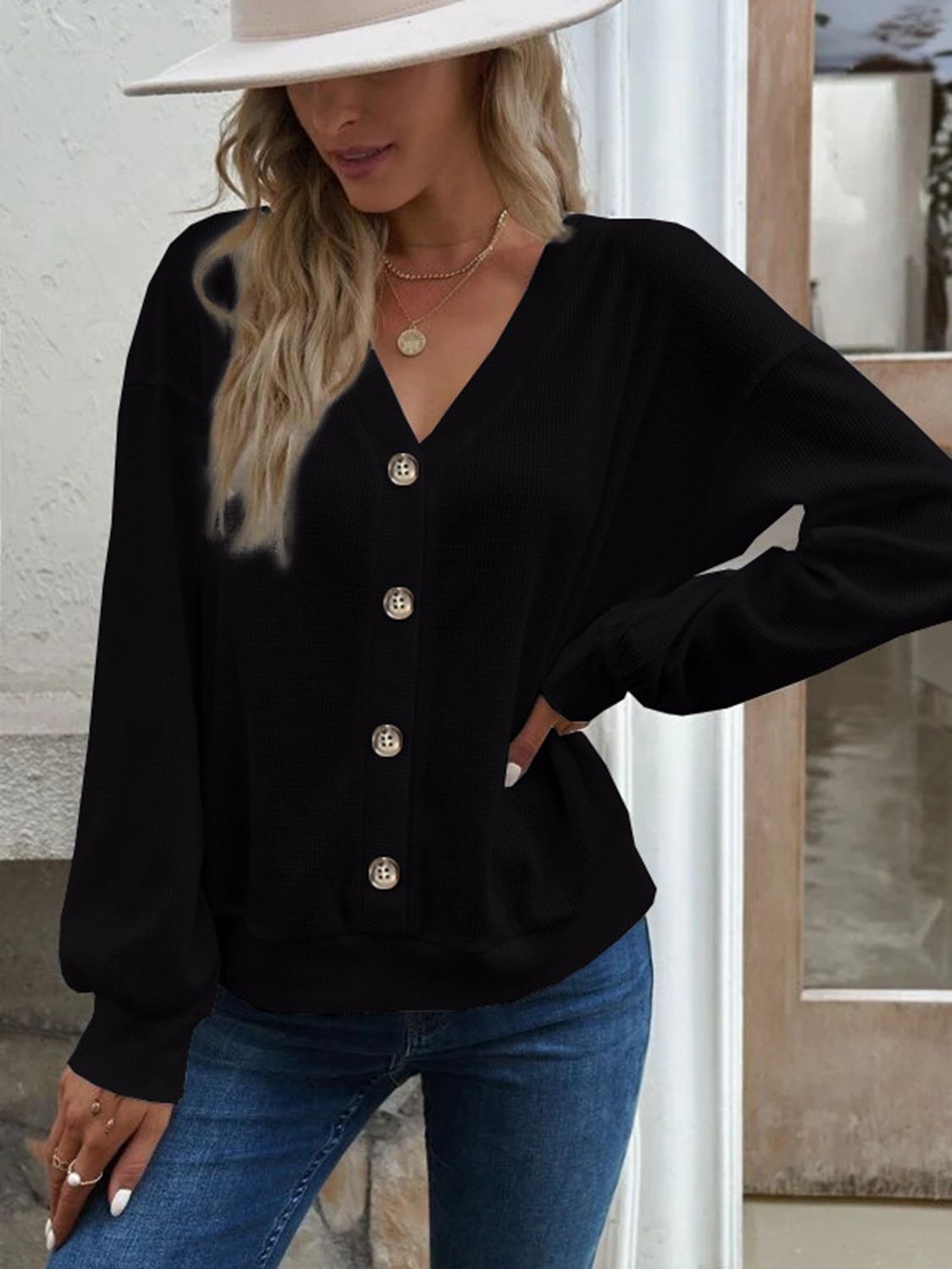 Front view of the Elowen black waffle-knit V-neck blouse, displaying its classic and versatile appeal.