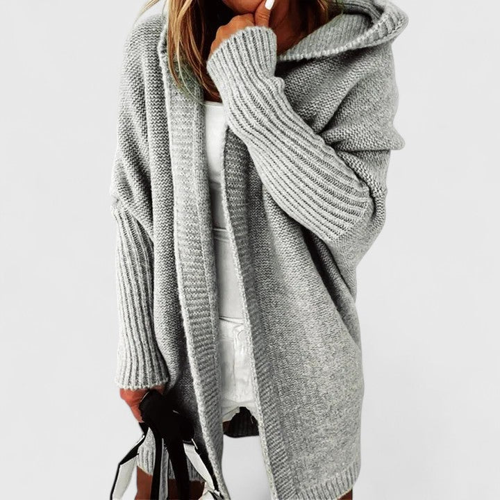 Side profile of a woman in the grey Elysia hooded open front cardigan, illustrating its length and drape.