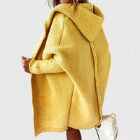 A folded yellow Elysia hooded cardigan displayed on a neutral background, highlighting its material and colour.