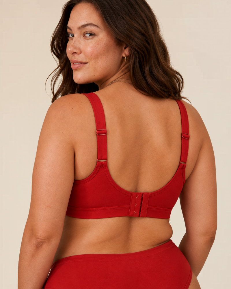 A hand gently stretching the fabric of the wireless comfort bra, illustrating its flexibility and softness.