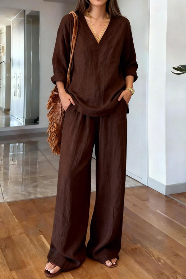 Back view of the white Genevieve co-ord set, emphasizing the flow of the long-sleeved top and ankle-length trousers.