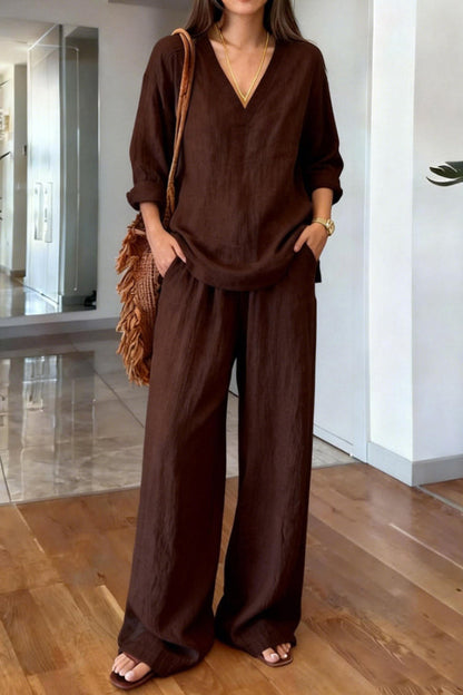 Back view of the white Genevieve co-ord set, emphasizing the flow of the long-sleeved top and ankle-length trousers.