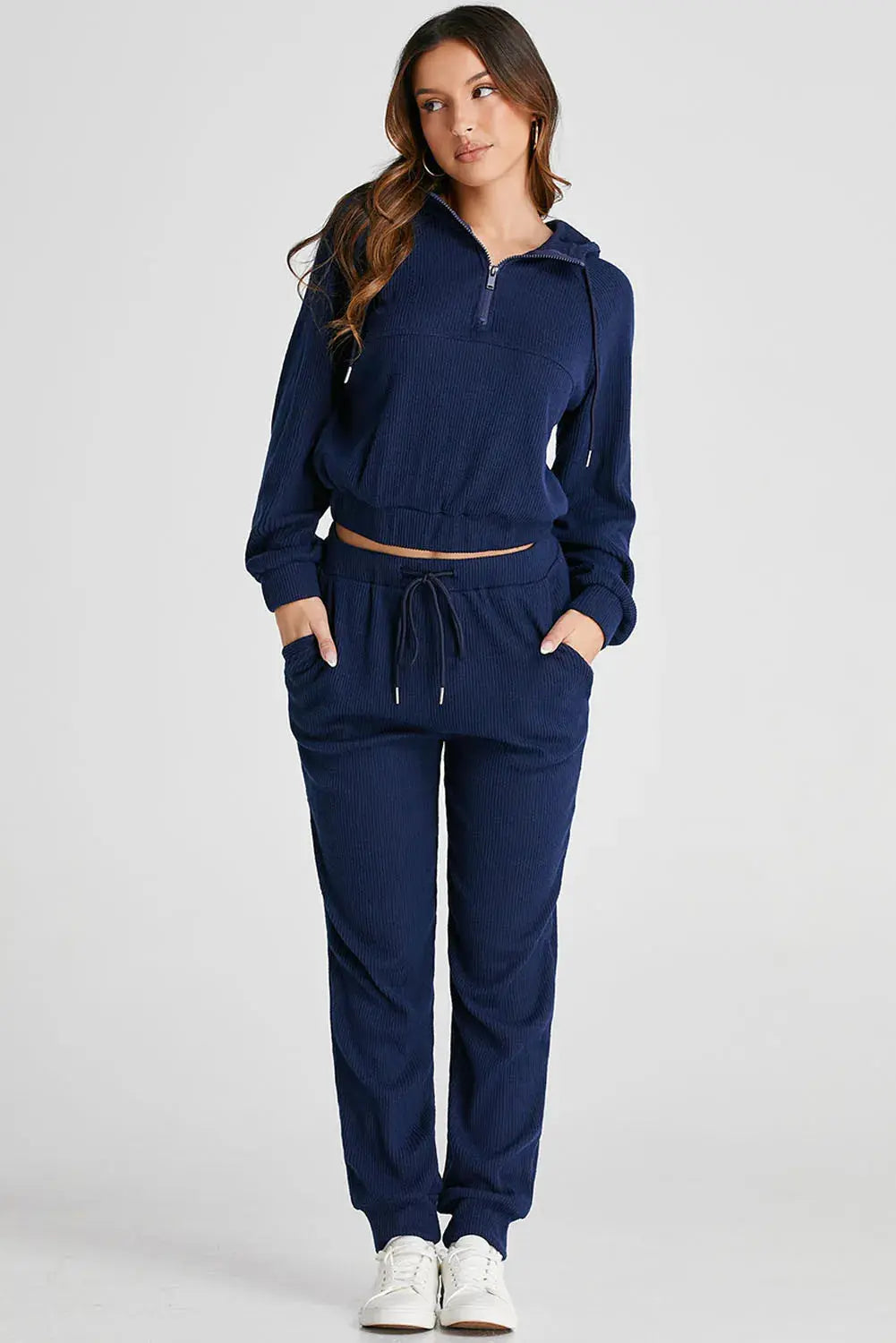 Side profile of a woman wearing the Hadley navy active set, highlighting the relaxed fit and drawstring detail of the hoodie.