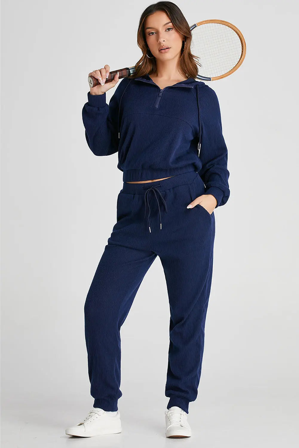 Close-up of the half-zip detail on the navy Hadley active set hoodie, showing the fabric texture and quality.