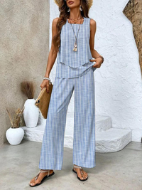 Lifestyle shot of a woman enjoying a casual outdoor setting while wearing the blue Anya two-piece set.