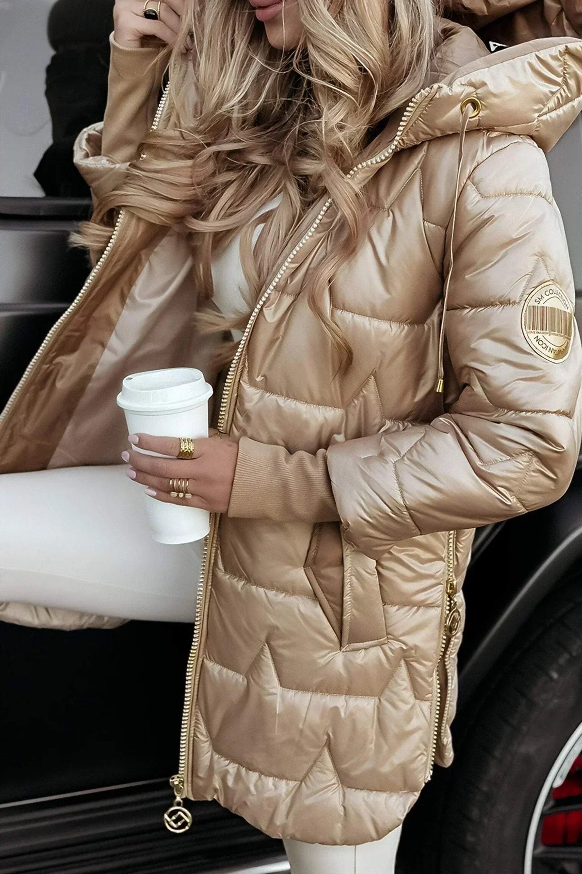 The Inez hooded winter jacket laid flat, displaying its full padded construction and hood.