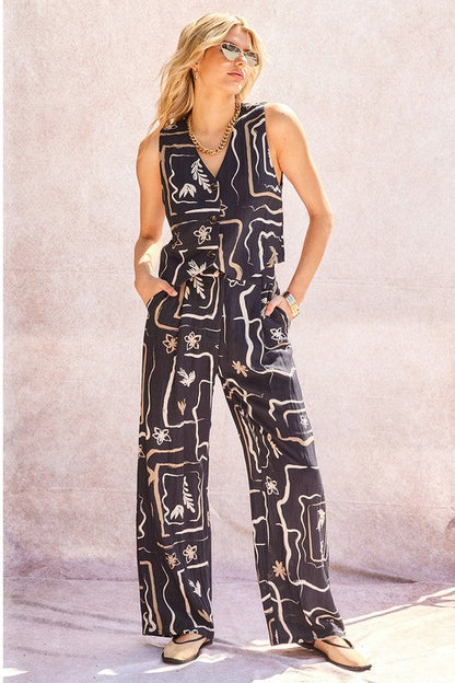 Front view of unique patterned wide-leg trousers on a model, showcasing the full silhouette.