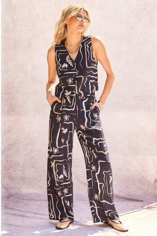 Front view of unique patterned wide-leg trousers on a model, showcasing the full silhouette.