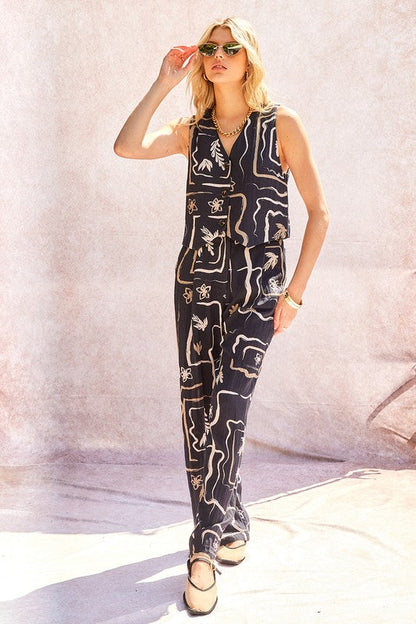 Model accessorising the wide-leg trousers for an evening spring event.