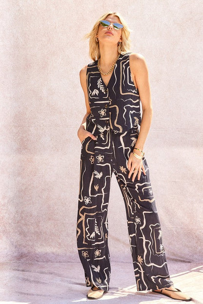 Side profile of the model wearing the patterned wide-leg trousers, highlighting the fabric drape.
