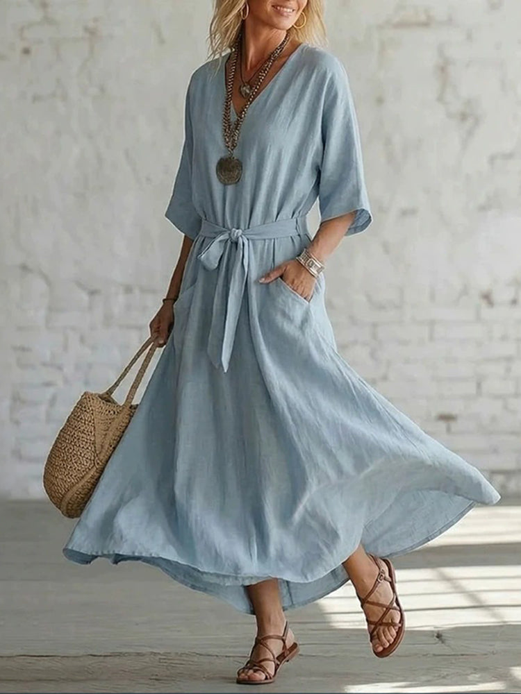 Front view of the Isolde elegant V-neck maxi dress in a soft blue, showcasing its flowing ankle-length silhouette.