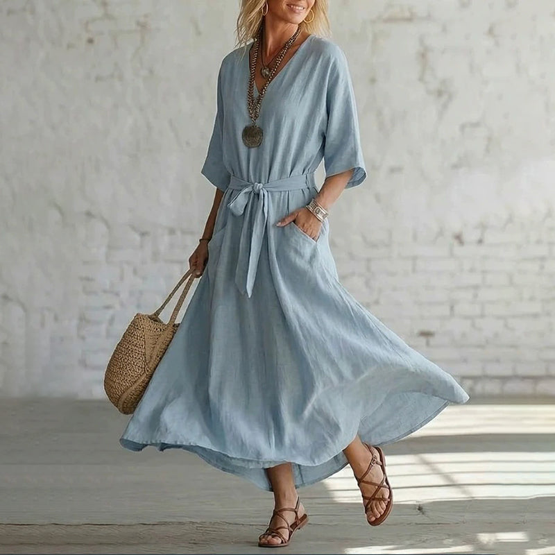 Detailed shot of the V-neck and tie design on the Isolde cotton linen maxi dress, highlighting fabric texture.