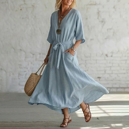 Detailed shot of the V-neck and tie design on the Isolde cotton linen maxi dress, highlighting fabric texture.