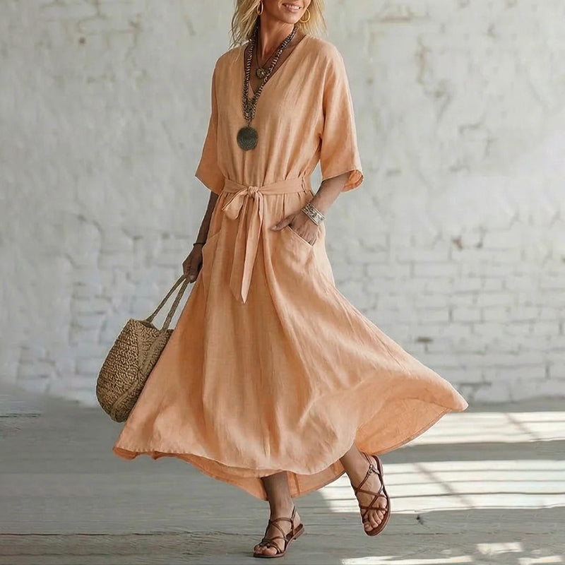 Close-up of the half sleeve and paneled construction of the elegant V-neck maxi dress, revealing craftsmanship.