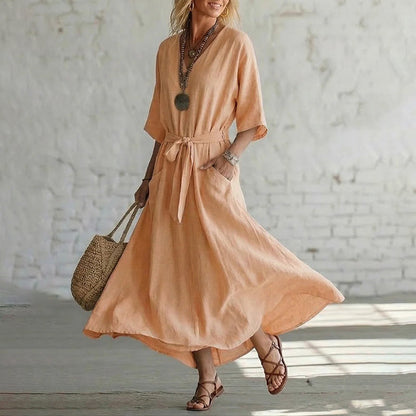 Close-up of the half sleeve and paneled construction of the elegant V-neck maxi dress, revealing craftsmanship.