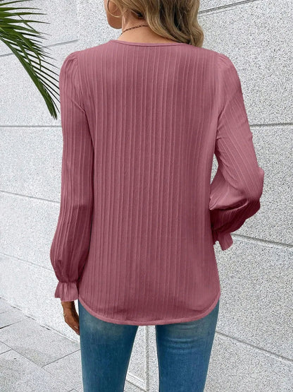 Detail shot of the flounce sleeve on the sky blue Seraphine blouse, capturing its gentle movement.