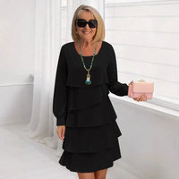 Front view of the Serena elegant ruffle dress in black, showcasing its flowing A-line silhouette and long sleeves.