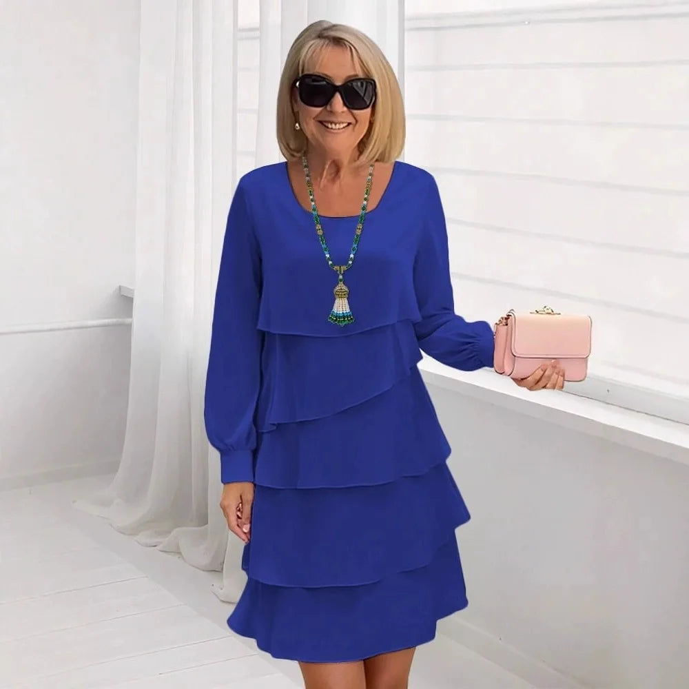 Woman wearing the blue Serena elegant ruffle dress, styled with subtle accessories for a chic, comfortable look.