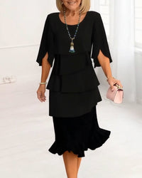 Front view of the navy Serena elegant comfort ruffle dress, featuring a classic round neckline and A-line silhouette.