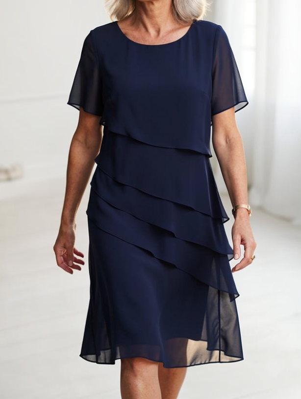 Front view of the Calla elegant ruffle midi dress in navy blue, showcasing its layered flowing design.