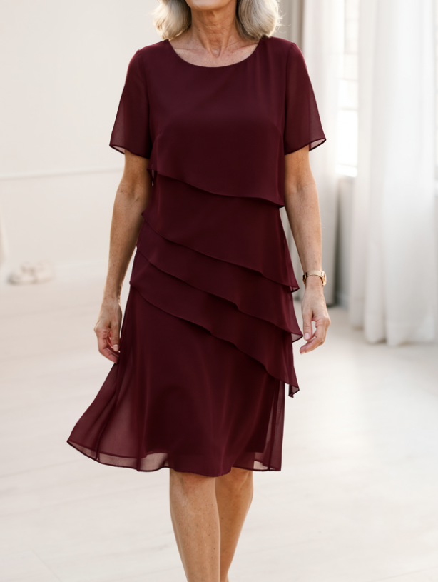 Close-up detail of the chiffon blend fabric and delicate ruffles on the elegant midi dress.