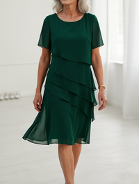 Back view of the Calla elegant ruffle midi dress, showing the graceful drape and midi length.