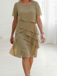 Lifestyle shot of a woman enjoying a relaxed outing in the comfortable Calla elegant ruffle midi dress.