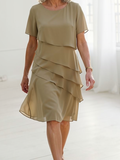 Lifestyle shot of a woman enjoying a relaxed outing in the comfortable Calla elegant ruffle midi dress.
