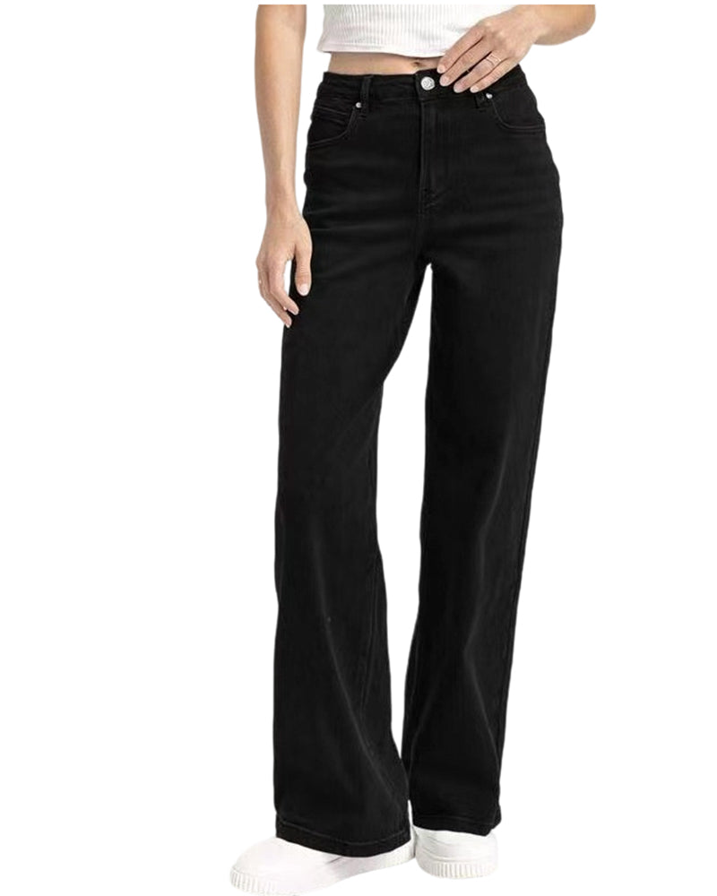 Stack of folded Juniper relaxed straight leg jeans in various colours (blue, sky blue, black, brown) on a shelf.