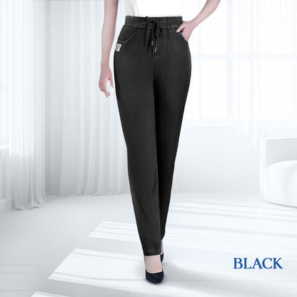 Model demonstrating the flexibility of the mom jeans by bending, highlighting the 4-way stretch.