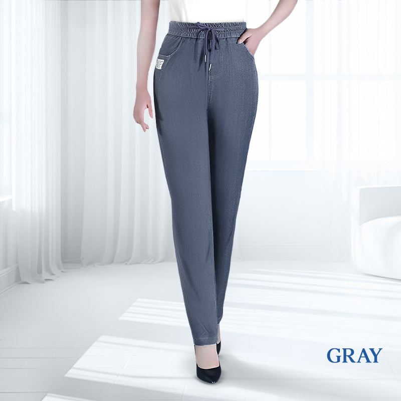 Overhead shot of the dark grey ultra-stretch mom jeans neatly folded, emphasizing their versatile colour.