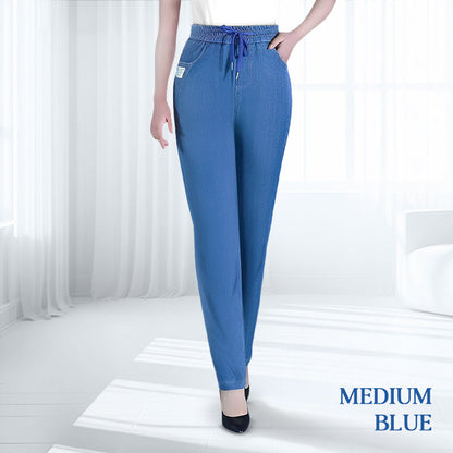 Woman standing casually, showcasing the full length and drape of the high-waisted mom jeans.