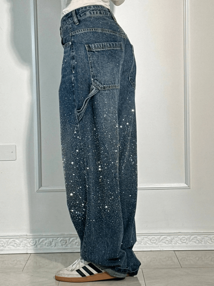 Women's dark blue balloon carpenter jeans styled with a casual top, captured from a side angle.