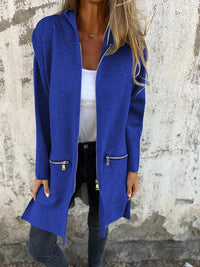 Flat lay of a folded women's purple hooded longline cardigan, emphasizing its soft material and compact storage.