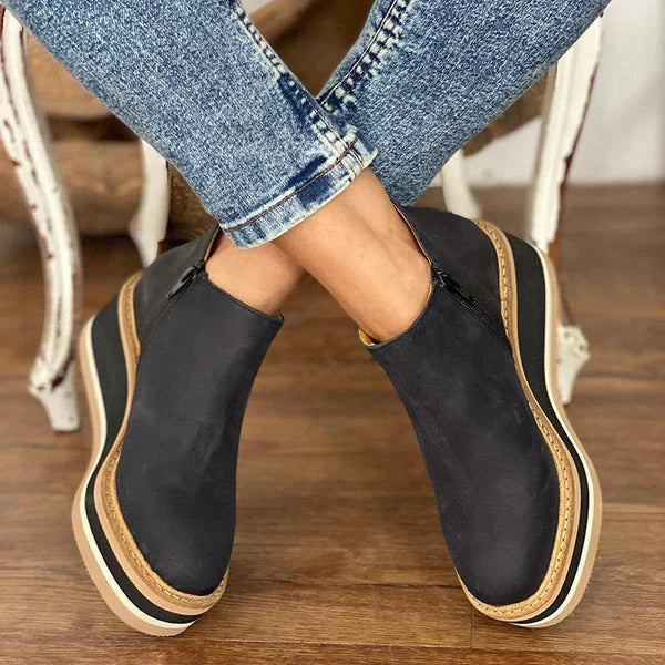 Side profile of black Zara women's low ankle boots, highlighting the convenient side zip closure.