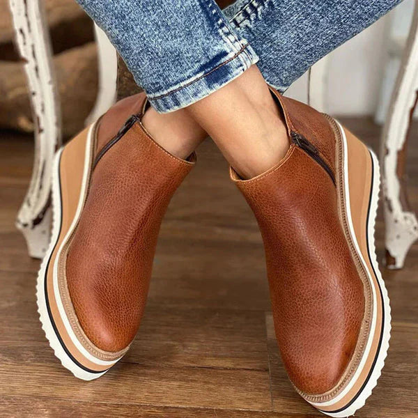 Close-up detail of beige Zara women's low ankle boots, focusing on the texture and stitching.