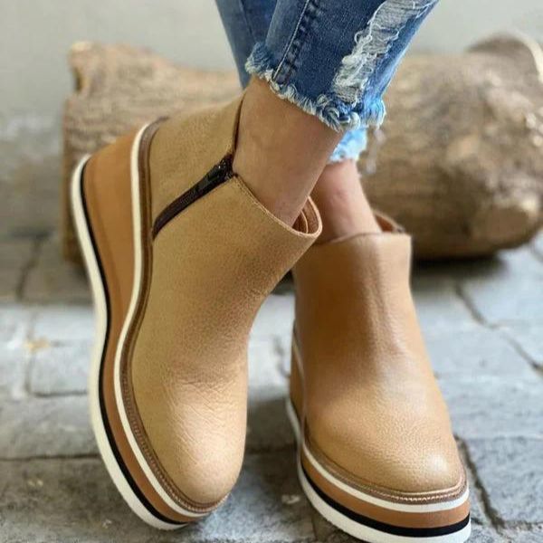 Lifestyle shot of a woman wearing dark brown Zara women's low ankle boots with casual attire, walking outdoors.