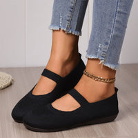 Woman slipping on a pair of comfortable Linnea ballet flats, illustrating the ease of wear.