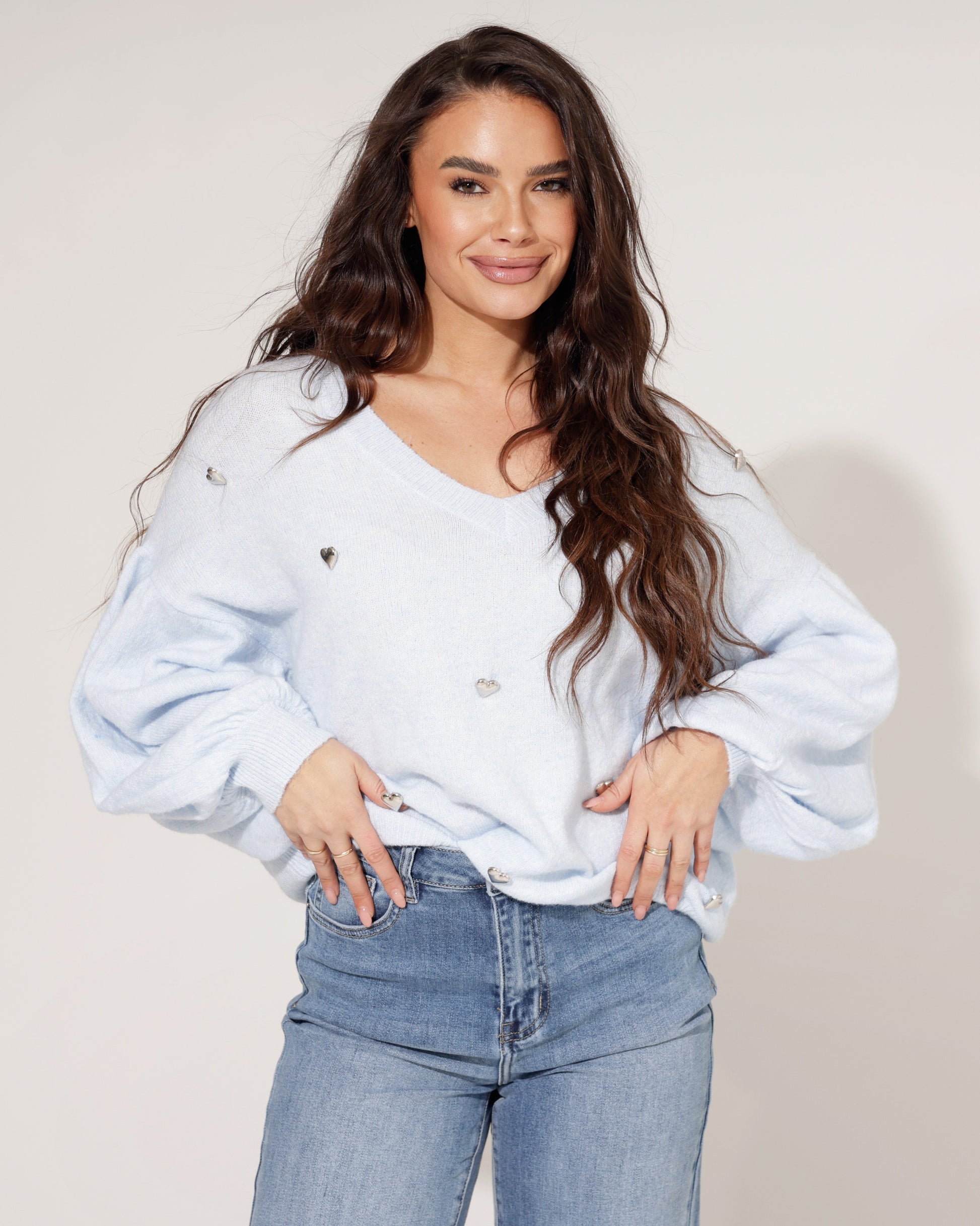 Side profile of a model wearing the Liora light blue knit jumper, demonstrating its comfortable drape.