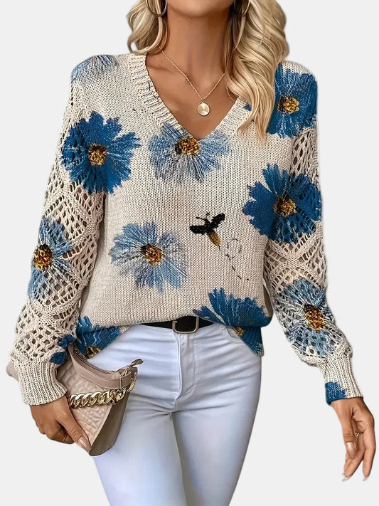 Front view of a blue floral knit V-neck sweater, showcasing the intricate pattern and relaxed fit.