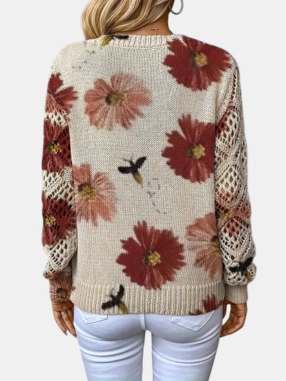 Red floral knit V-neck sweater draped over a chair, highlighting its versatile appeal.