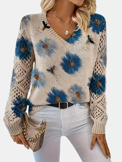 Front hem detail of a green floral knit sweater, with a focus on the ribbed band.