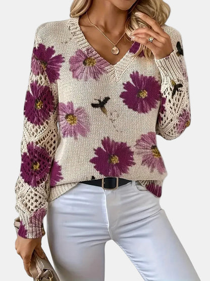 Blue floral knit V-neck sweater paired with accessories like a necklace, showing styling potential.